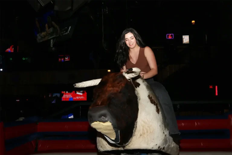 Saddle up and experience the thrill of Stampede Houston's mechanical bull! Our bull riding experience is a highlight of Houston's nightlife scene, offering excitement and adventure for all.